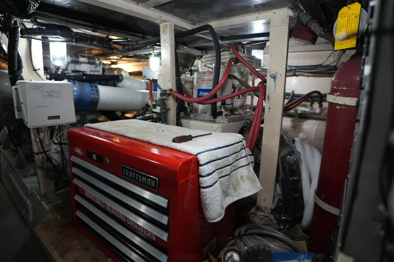 Slide: The Image of Engine room of a 1980 Hatteras 50 Convertible with tools and equipment. - 62