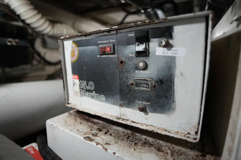 Slide: The Image of Control panel of a 1980 Hatteras 50 Convertible boat, featuring switches and indicators. - 63