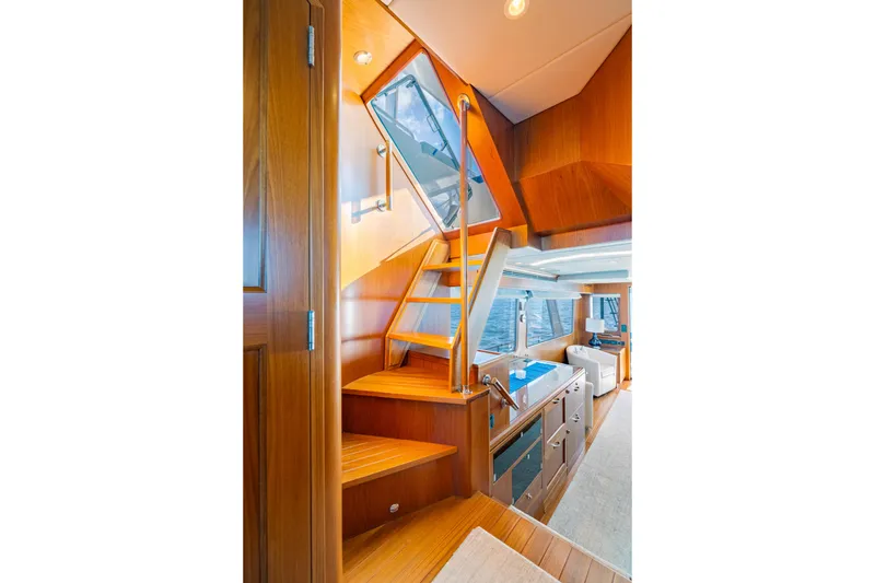 Slide: The Image of Luxurious interior of 2023 Offshore Yachts 64 ELV, featuring elegant wooden staircase and modern design. - 19