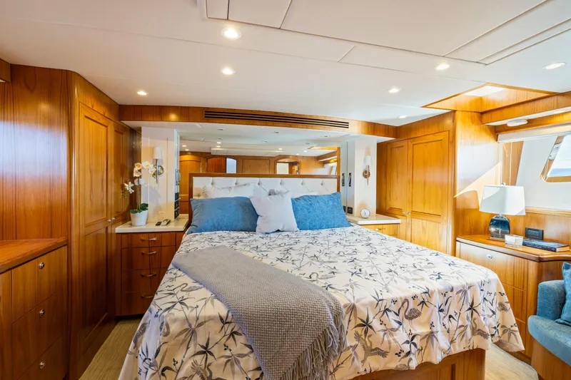 Slide: The Image of Luxurious 2023 Offshore Yachts 64 ELV bedroom with elegant wood paneling and cozy bedding. - 21