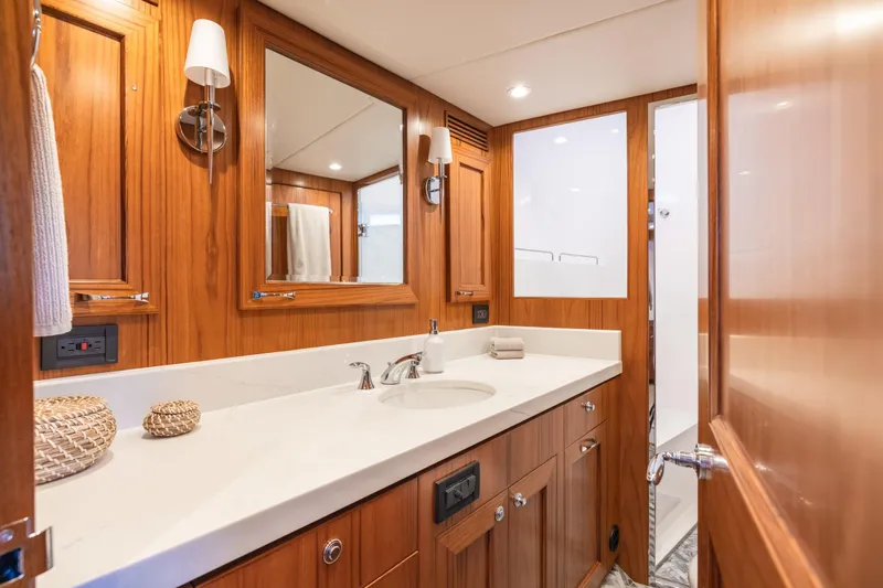 Slide: The Image of Luxurious bathroom interior of 2023 Offshore Yachts 64 ELV with wooden cabinetry and modern fixtures. - 24