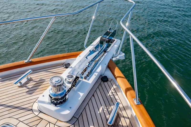 Slide: The Image of Bow of 2023 Offshore Yachts 64 ELV with polished deck fittings and railing. - 34