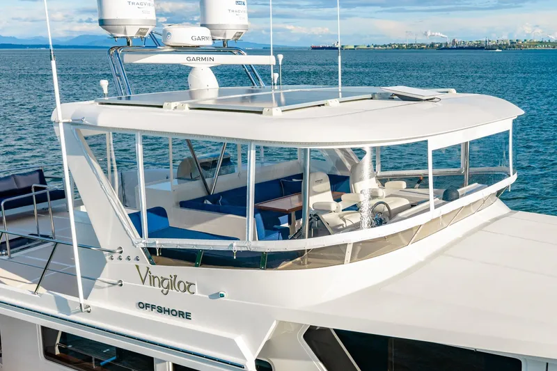Slide: The Image of 2023 Offshore Yachts 64 ELV on serene ocean, showcasing sleek design and advanced navigation equipment. - 45