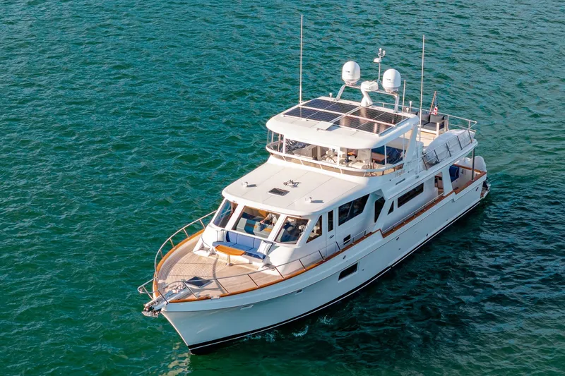Slide: The Image of 2023 Offshore Yachts 64 ELV cruising on open water, showcasing luxury design and solar panels. - 46