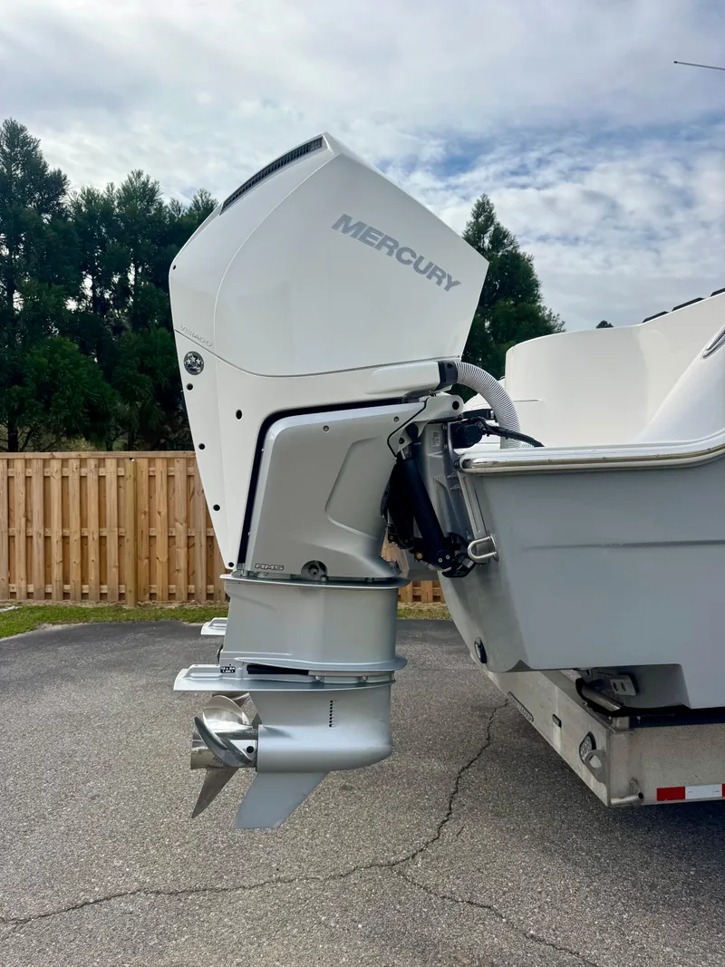 Slide: The Image of 2022 Invincible 35 Catamaran with Mercury outboard engine, parked on a trailer. - 4