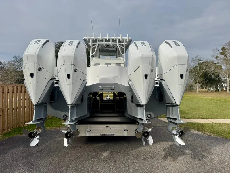 Slide: The Image of 2022 Invincible 35 Catamaran with four powerful outboard engines, parked on a driveway. - 5
