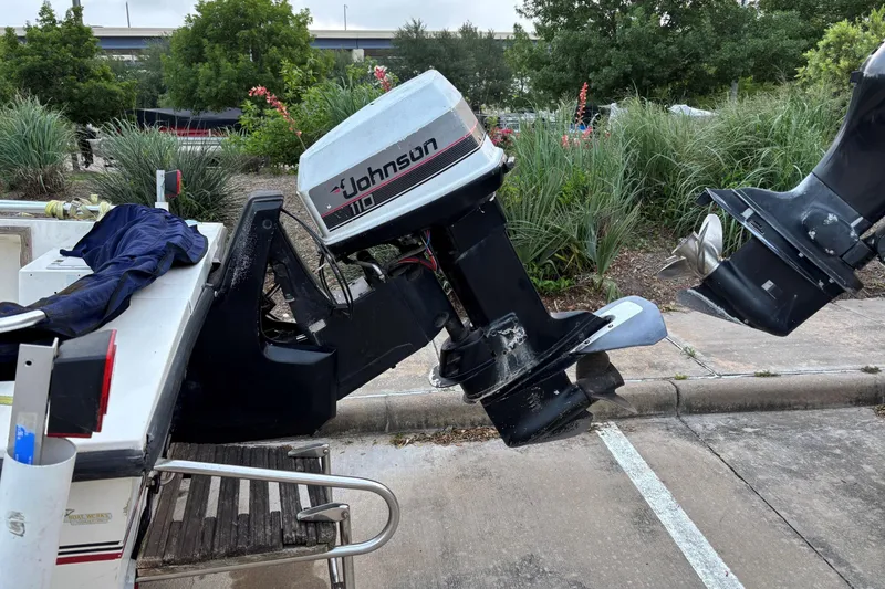 Slide: The Image of 1985 Pro-Line 170 Center Console with Johnson 110 outboard motor in a parking area. - 2