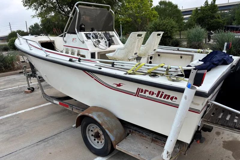 Slide: The Image of 1985 Pro-Line 170 Center Console boat on trailer, parked outdoors. - 3