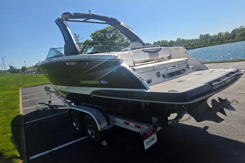 Slide: The Image of 2018 Chaparral 267 SSX boat on trailer near a lake, sunny day. - 1
