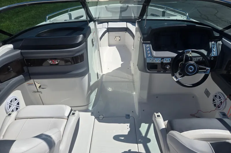 Slide: The Image of 2018 Chaparral 267 SSX boat interior with sleek dashboard and comfortable seating. - 11