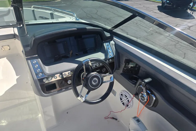 Slide: The Image of Cockpit view of 2018 Chaparral 267 SSX boat with modern steering and controls. - 12