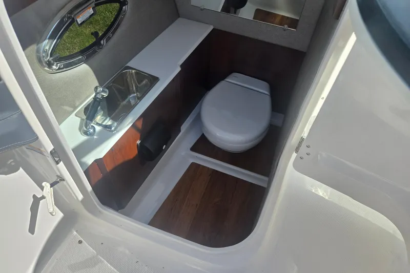 Slide: The Image of 2018 Chaparral 267 SSX boat interior with sink and toilet. - 15