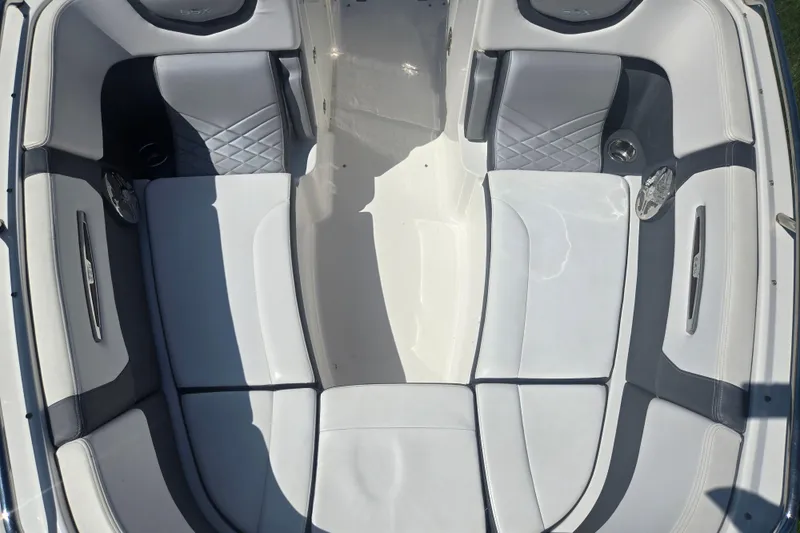 Slide: The Image of 2018 Chaparral 267 SSX boat interior with white and gray seating. - 19
