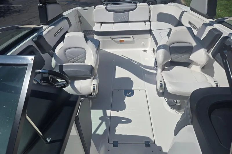 Slide: The Image of 2018 Chaparral 267 SSX boat interior with white seating and steering wheel. - 21