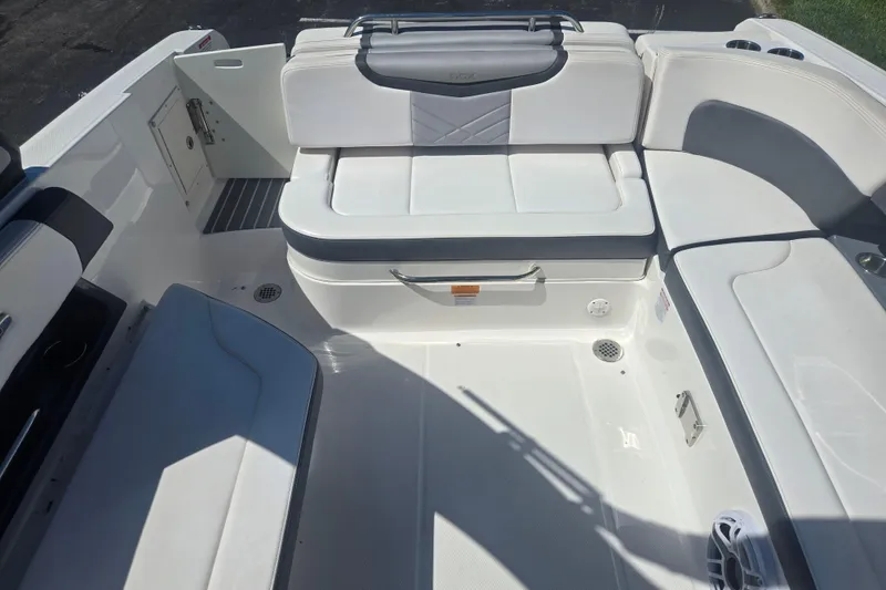Slide: The Image of 2018 Chaparral 267 SSX boat interior with white seating and storage compartments. - 22