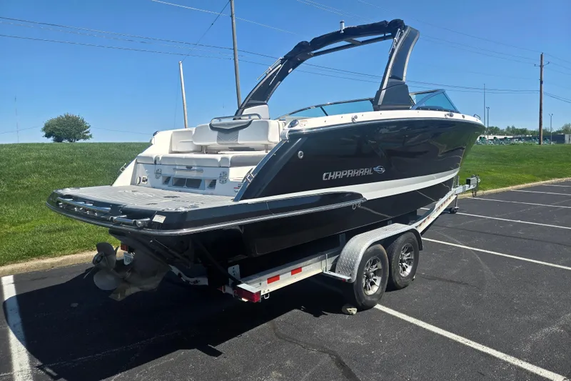 Slide: The Image of 2018 Chaparral 267 SSX boat on trailer in parking lot, sunny day. - 3