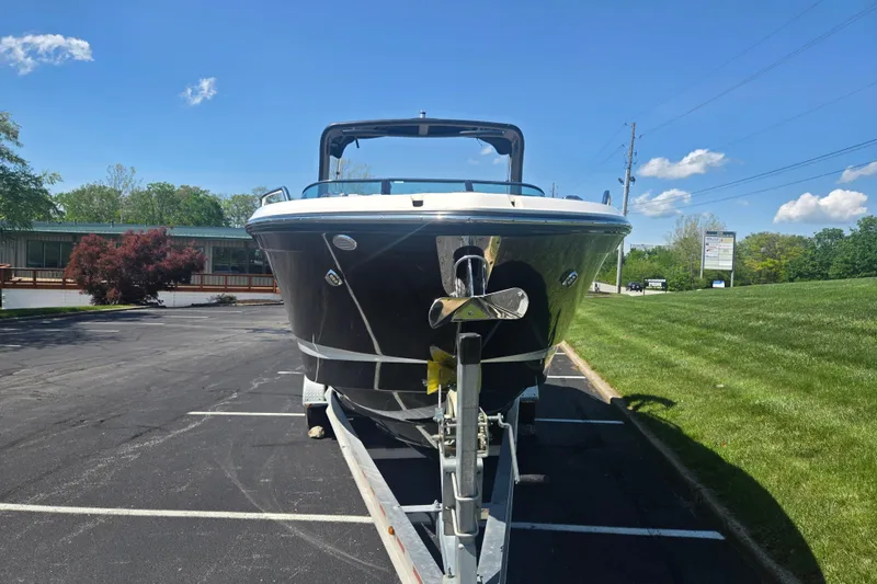 Slide: The Image of 2018 Chaparral 267 SSX boat on trailer in parking lot, sunny day. - 6