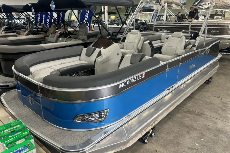 The Image of 2022 Tahoe Pontoon Cascade Quad Lounger in showroom, featuring sleek blue design and spacious seating. - 0