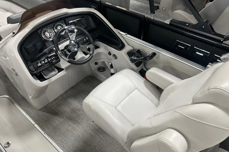 Slide: The Image of 2022 Tahoe Pontoon Cascade Quad Lounger helm with steering wheel and control panel. - 4
