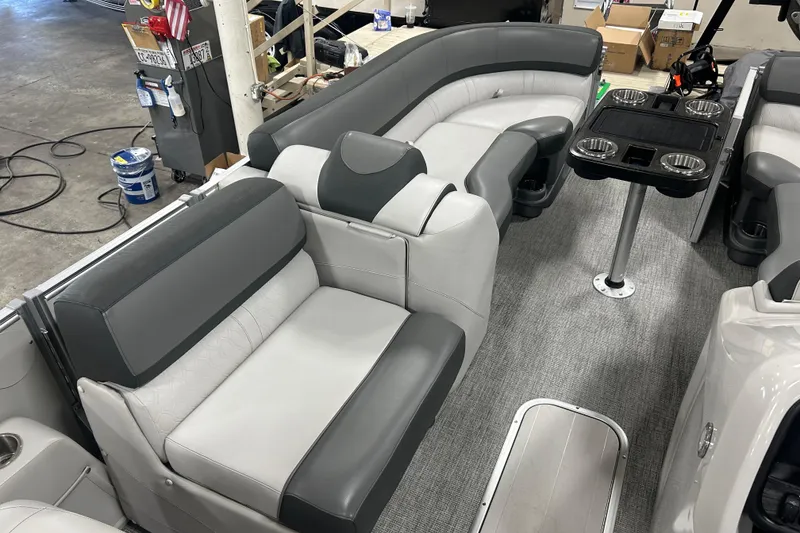 Slide: The Image of 2022 Tahoe Pontoon Cascade Quad Lounger interior with gray seating and cup holders. - 5