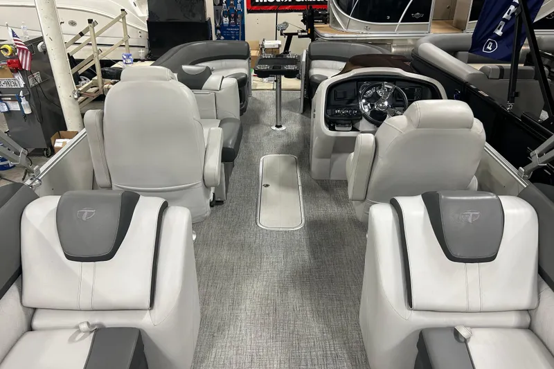 Slide: The Image of 2022 Tahoe Pontoon Cascade Quad Lounger interior with luxurious seating and modern dashboard. - 6