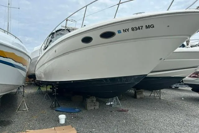 The Image of 2001 Sea Ray 38 Sundancer boat on stands, gravel lot, registration NY 8347 MG. - 0