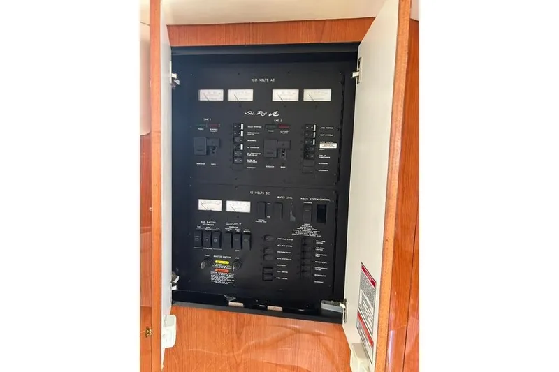 Slide: The Image of Electrical panel of a 2001 Sea Ray 38 Sundancer boat, showcasing controls and meters. - 10