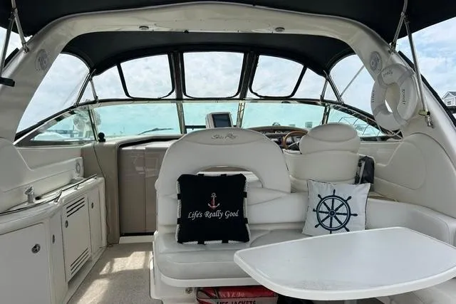 Slide: The Image of Interior of a 2001 Sea Ray 38 Sundancer yacht with plush seating and nautical decor. - 3