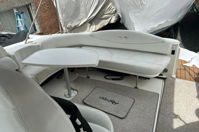 Slide: The Image of 2001 Sea Ray 38 Sundancer boat interior with white seating and table. - 4