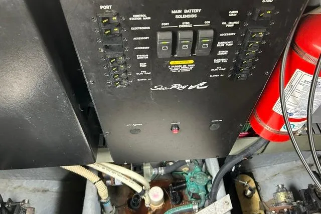 Slide: The Image of Control panel of a 2001 Sea Ray 38 Sundancer boat with visible wiring and fire extinguisher. - 7