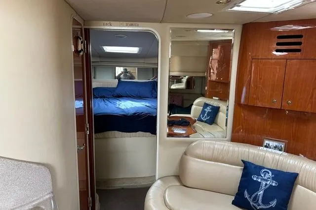 Slide: The Image of Interior of 2001 Sea Ray 38 Sundancer yacht with cozy seating and nautical decor. - 9