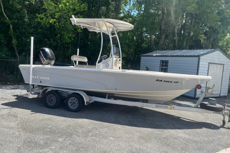 The Image of 2021 Sea Chaser 21 LX boat on trailer, parked outdoors near a shed. - 0