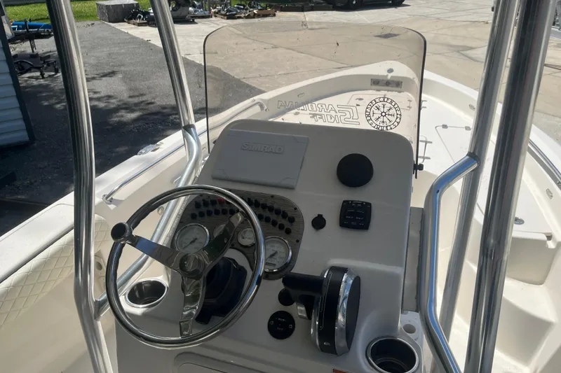 Slide: The Image of 2021 Sea Chaser 21 LX boat console with steering wheel and controls. - 11