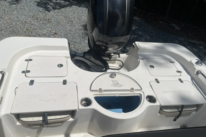 Slide: The Image of 2021 Sea Chaser 21 LX boat deck with storage compartments and motor. - 15