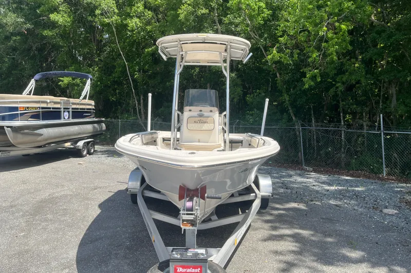 Slide: The Image of 2021 Sea Chaser 21 LX boat on trailer, parked outdoors near trees. - 6