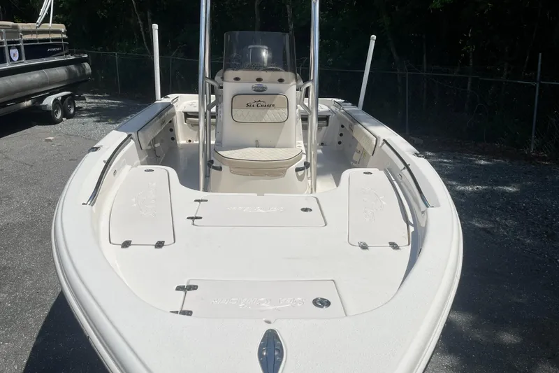 Slide: The Image of 2021 Sea Chaser 21 LX boat, white deck, parked outdoors. - 7