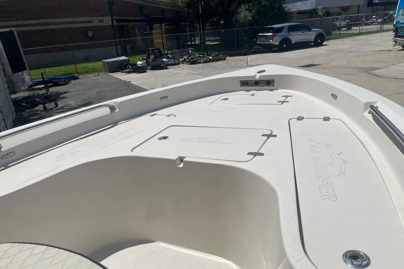 Slide: The Image of 2021 Sea Chaser 21 LX boat deck, featuring storage compartments and sleek design. - 8