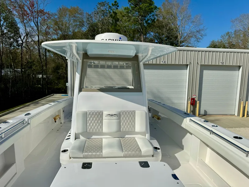 Slide: The Image of 2020 Invincible 37 Catamaran with sleek seating, docked near storage units. - 10