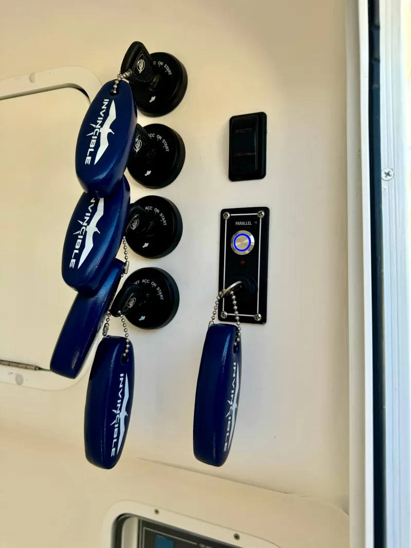 Slide: The Image of Invincible 37 Catamaran 2020 control panel with blue key floats and switches. - 15