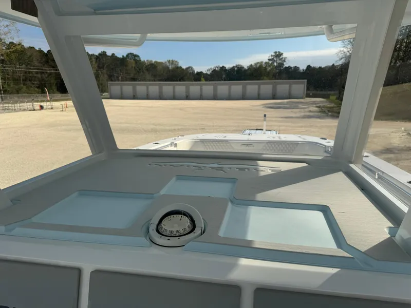 Slide: The Image of 2020 Invincible 37 Catamaran dashboard view with open storage compartments. - 21