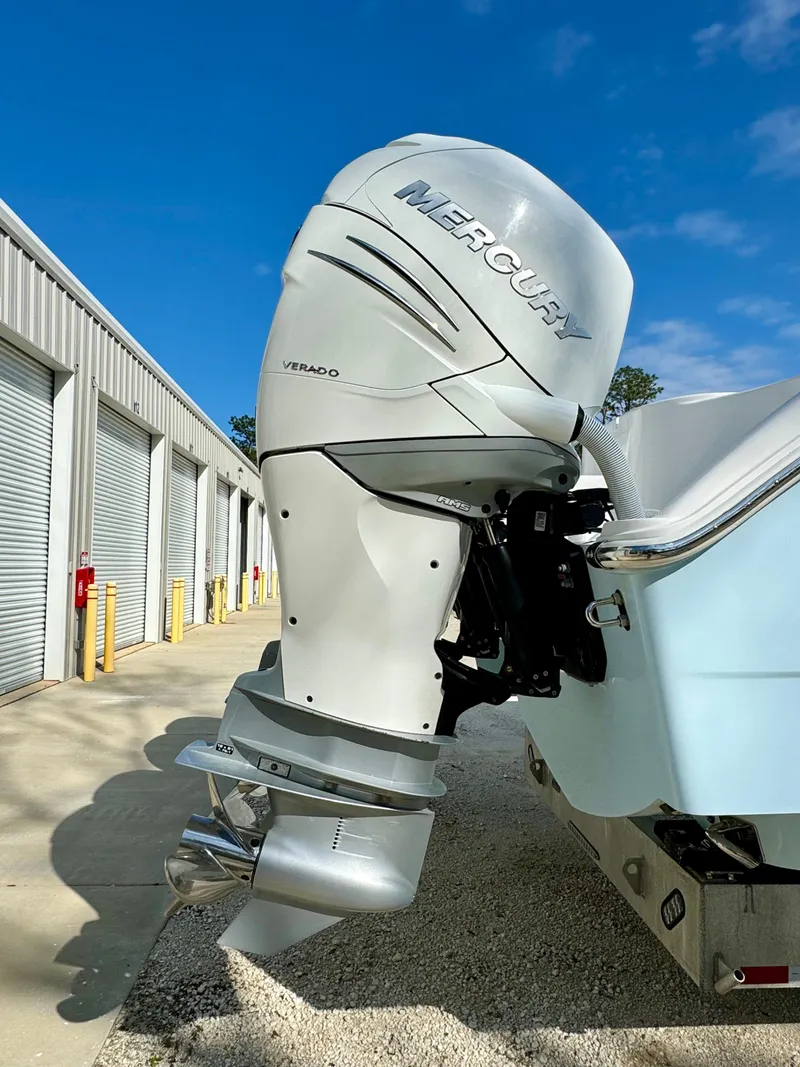 Slide: The Image of Mercury Verado outboard motor on 2020 Invincible 37 Catamaran, parked near storage units. - 3