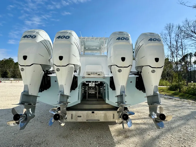 Slide: The Image of 2020 Invincible 37 Catamaran with four powerful outboard engines, parked outdoors. - 5