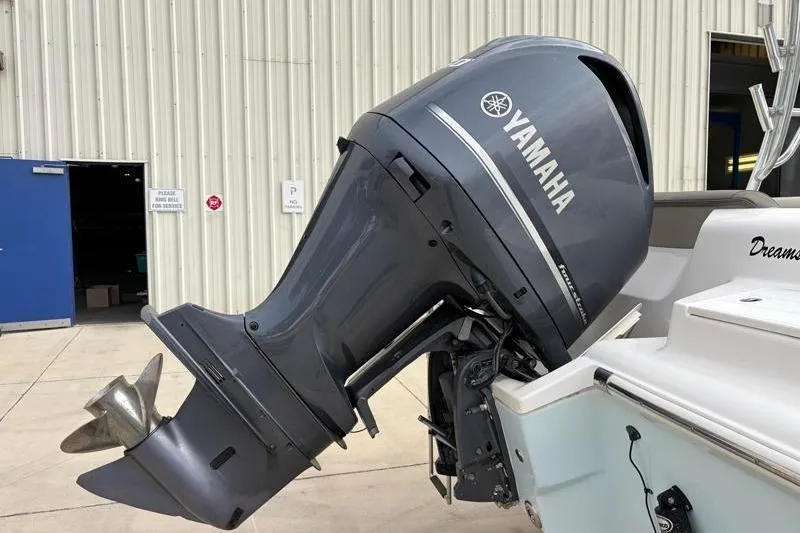 Slide: The Image of 2024 Key West 239 DFS boat with Yamaha outboard motor, parked near a building. - 14
