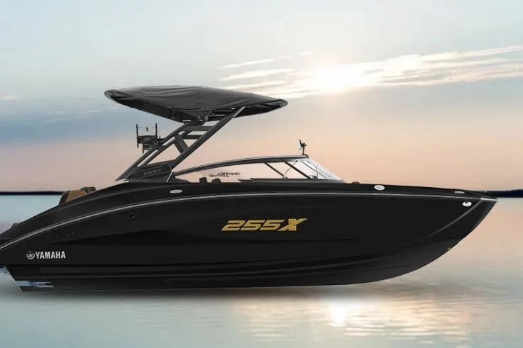 The Image of 2026 Yamaha Boats 255XD on calm water at sunset. - 1