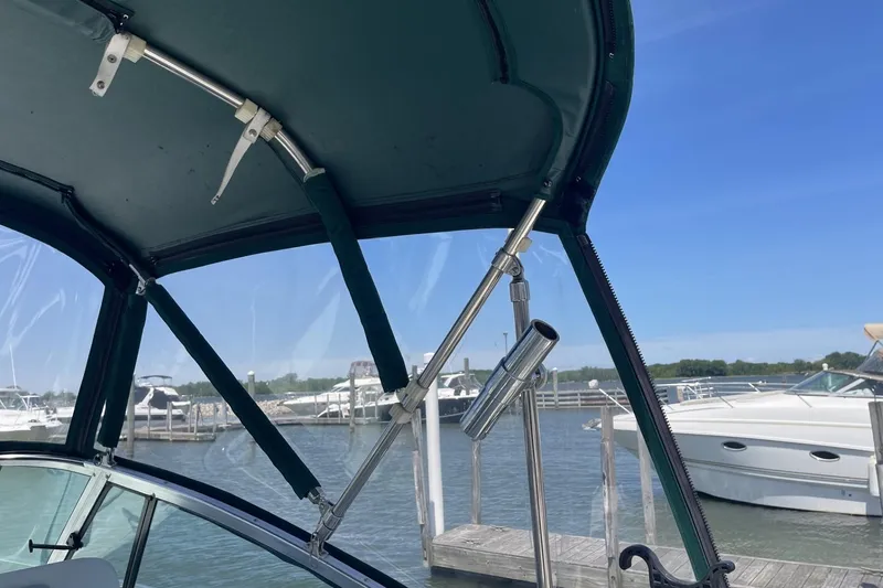 Slide: The Image of 1997 Stamas 310 Express boat interior with marina view and clear blue sky. - 12