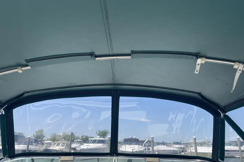Slide: The Image of 1997 Stamas 310 Express boat interior with marina view through windows. - 13