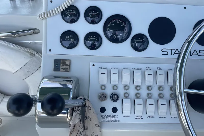 Slide: The Image of Control panel of a 1997 Stamas 310 Express boat with gauges and switches. - 16