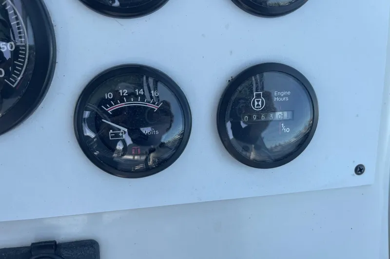 Slide: The Image of Close-up of 1997 Stamas 310 Express boat gauges showing volts and engine hours. - 21
