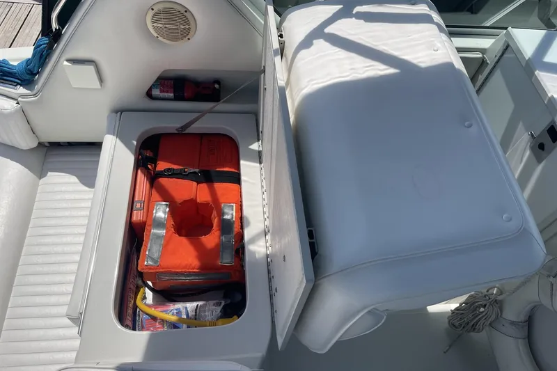 Slide: The Image of Storage compartment on 1997 Stamas 310 Express boat with life jacket and safety equipment. - 23