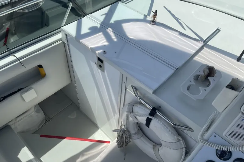 Slide: The Image of Interior view of a 1997 Stamas 310 Express boat, featuring seating and storage areas. - 24